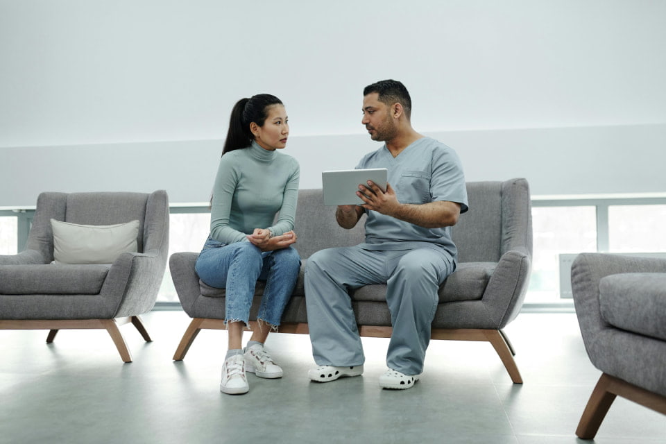 man and woman on couch holding tablet