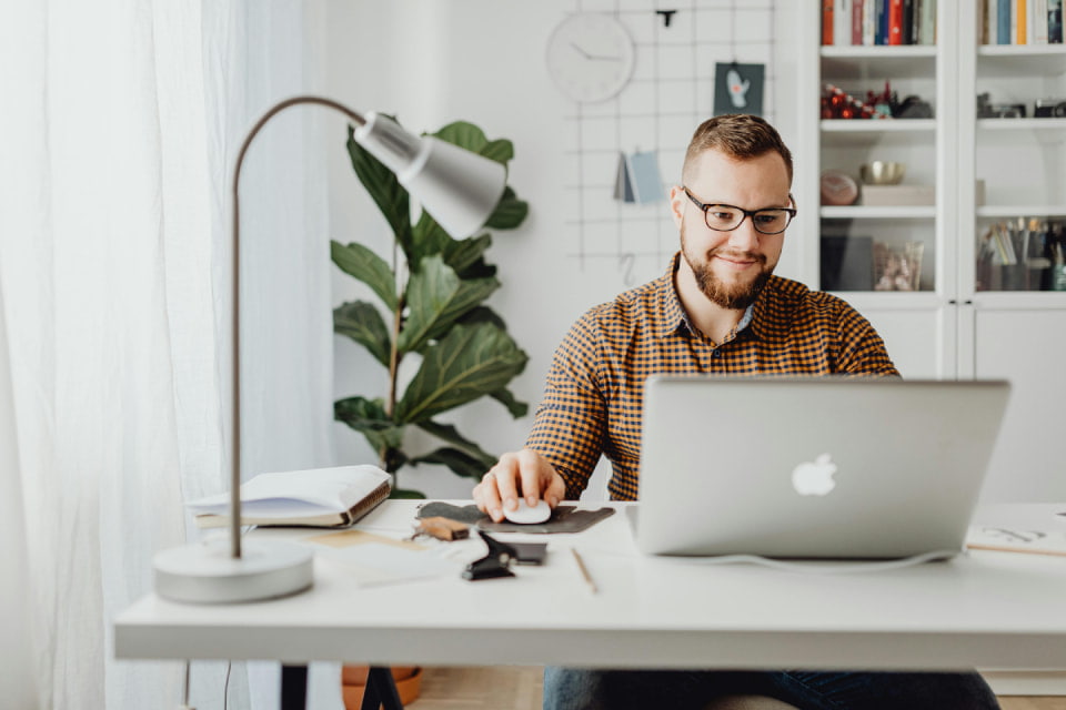 man in modern room looking at laptop conseling